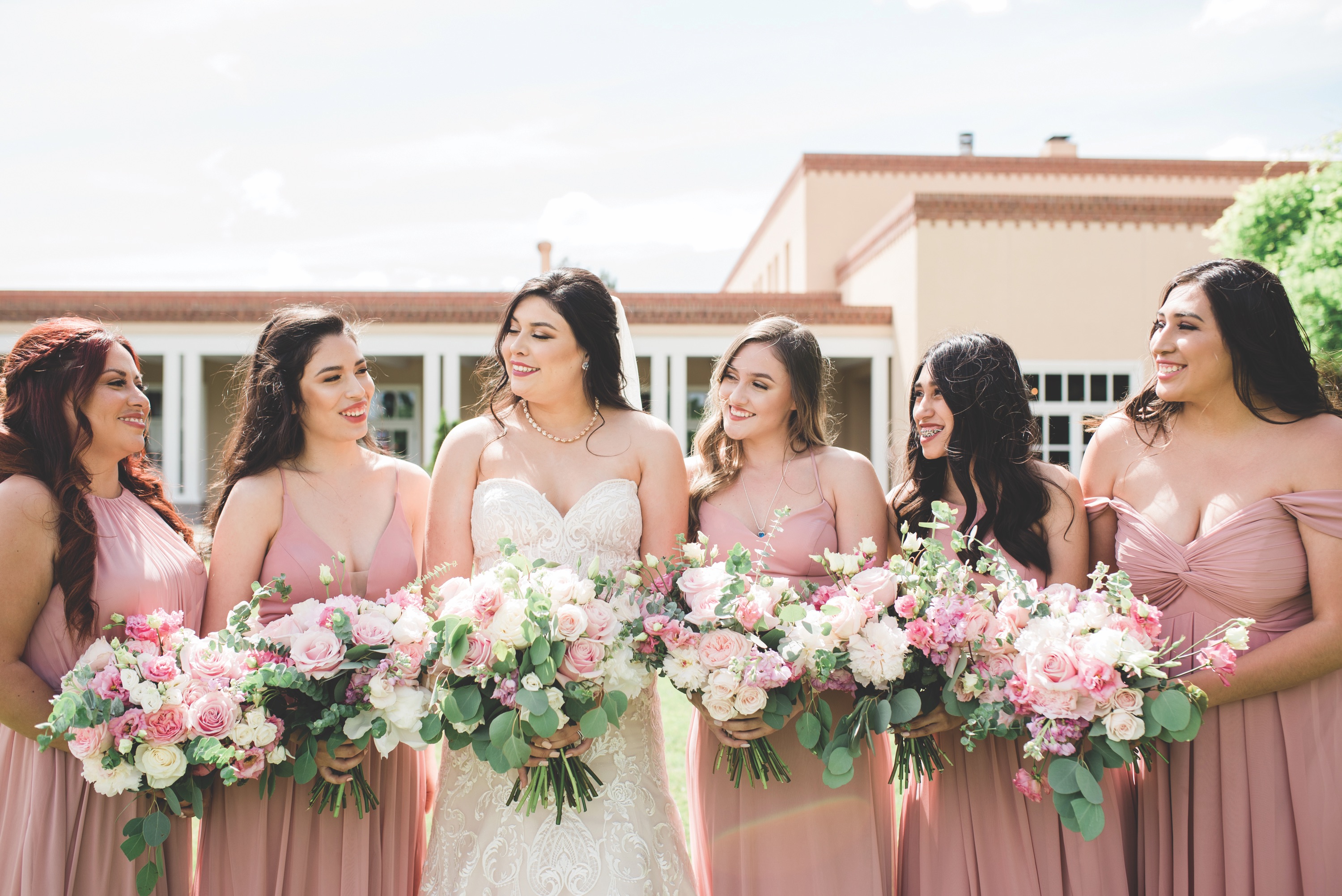 bride smiling at her bridesmaids, bride, new mexico bride, hotel albuquerque at old town, abq flowers, new mexico weddings, perfect wedding guide